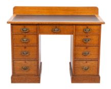 An oak desk in George III style, circa 1925; the rectangular top with raised back gallery,
