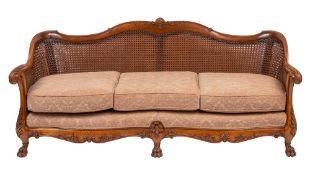 A carved walnut and canework Bergere suite,