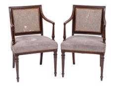 A pair of Regency mahogany and canework library elbow chairs,
