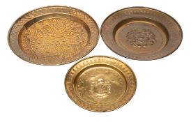 A Nuremberg brass alms dish and two later dishes,