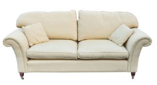 An upholstered and mahogany sofa, by Laura Ashley, circa 2005; with straight horizontal back,