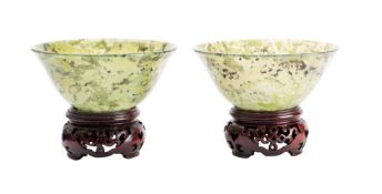 A pair of Chinese jade finger bowls of plain circular form with mottled inclusions,