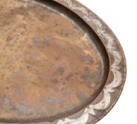 An Arts and Crafts period copper tea tray of oval outline, with silvered scalloped designed border,