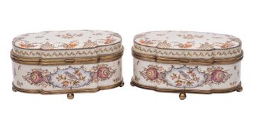 A pair of Continental metal-mounted porcelain boxes and hinged covers of cartouche form,