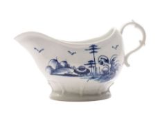A Longton Hall blue and white sauceboat of oval bombe form with raised moulded foot,
