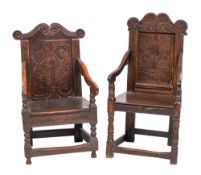 Two similar Jacobean carved oak wainscot elbow chairs,