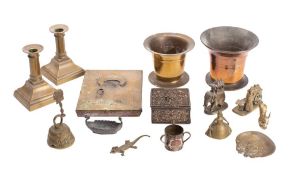 A 19th century bronze pestle of traditional design, a pair of brass candlesticks,