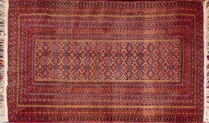 A Turkoman Rug, the hooked and serrated lozenge geometric field enclosed by a multiple border,