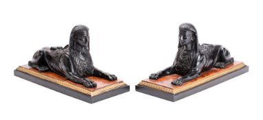A pair of 20th century resin models of sphinxes mounted on rectangular bases 28.5cm long.