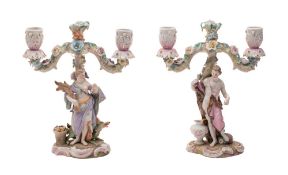 A pair of Meissen-style allegorical figural candlebra the branches applied with flowers and foliage,