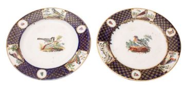 A pair of early 19th century English porcelain plates in the Tournai manner each painted with a