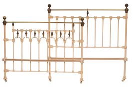 A brass and cream painted metal double bedstead,