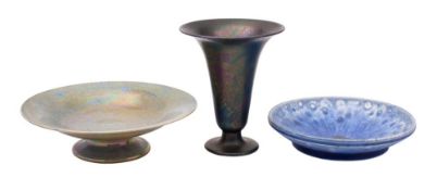 A Ruskin purple and black 'peacock' lustre glazed vase; a shallow bowl with mottled blue glaze;