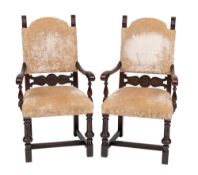 A pair of walnut and velvet upholstered elbow chairs in Continental 17th century taste,