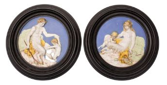 A pair of Italian maiolica roundels after Luca Della Robbia moulded in relief with mythological