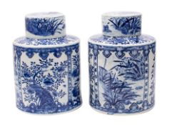 A large pair of Chinese blue and white tea jars and covers of cylindrical form,