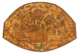 An early Georgian silk and woolwork oval panel depicting a basket containing a floral spray