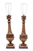 A pair of carved wood and gilt decorated table lamps of urn-shaped outline with slender spiral