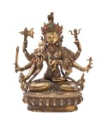 A bronze statue of a Hindu goddess possibly Durga, seated cross legged on a lotus flower base,