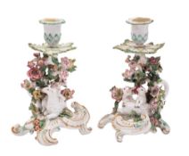 A matched pair of Chelsea ewe and lamb candlestick groups each with flowerhead sconces and foliate