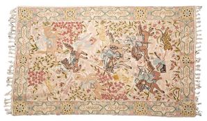 A Persian Crewel work rug decorated with mounted huntsman and animals enclosed by a floral meander