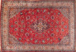 A Sarouk Carpet, the rose field with a central indigo shaped lozenge pole medallion,