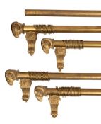 Four gilt metal curtain poles in Empire style, 20th century; comprising a pair,