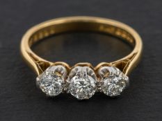 An 18ct gold, round, brilliant-cut diamond, three-stone ring, total estimated diamond weight ca. 0.