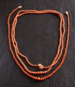 Two graduated coral bead necklaces, including one with a carved coral rose clasp,
