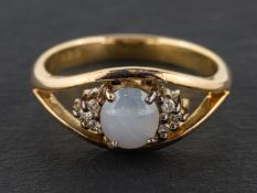 A cabochon-cut, oval, grey star sapphire and round, brilliant-cut diamond ring,