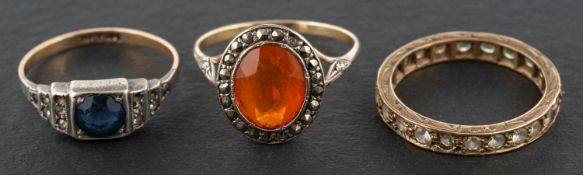 Three vari-coloured paste rings, the blue paste ring stamped '9CT' and 'SIL' ring sizes O & Q,