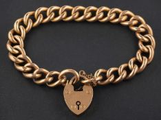 A curb-link bracelet with heart-shaped clasp, the clasp stamped '9CT', length of bracelet ca. 19.