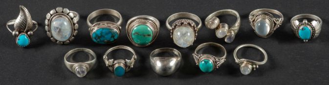 A collection of twelve rings, including gemset moonstone and turquoise rings,