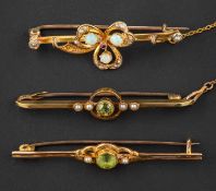 Three brooches, including two openwork, peridot and seed pearl bar brooches, one stamped '9CT',