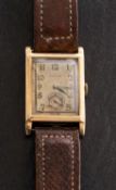 Rolex, a 1930s gentlemans gold rectangular wristwatch the dial having raised Arabic numerals,