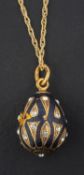 A black enamel and white paste, egg-shaped pendant, with control marks for Russia, Moscow,
