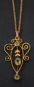 A cartouche-shaped, openwork, peridot pendant, together with a 9ct gold, bezel-link chain,