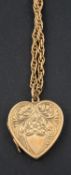 A heart-shaped locket pendant, with floral engraving and hallmarks for Birmingham, 1931,