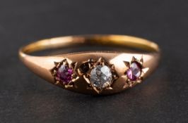 An old-cut diamond and probably garnet three-stone ring, estimated diamond weight ca. 0.