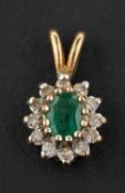 An oval, mixed-cut emerald and single-cut diamond cluster pendant, estimated emerald weight ca. 0.
