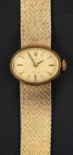 Rolex, a 1960's, 9ct gold, wristwatch, the gold-coloured, oval dial with baton markers and hands,