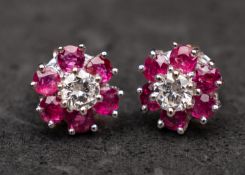 An 18ct gold pair of round, brilliant-cut diamond and ruby cluster ear studs,