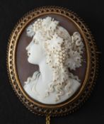 An Etruscan Revival shell cameo depicting a maenad, with ropework surround, total length ca. 4.