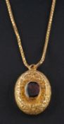 A late Victorian/ Edwardian, foiled back garnet, oval locket pendant,
