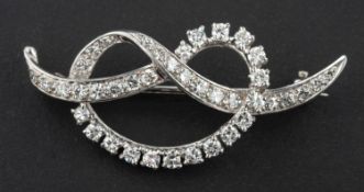 A round, brilliant-cut diamond bow brooch, total estimated diamond weight ca. 1.