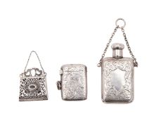 A filigree silver miniature purse 3cm wide, a silver vesta case and small silver scent bottle,