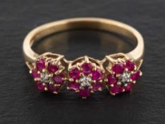 A 9ct gold ruby and diamond triple flowerhead ring, estimated total ruby weight ca. 0.
