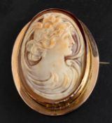 An Art Nouveau shell cameo brooch/ pendant, depicting Hebe, goddess of youth, stamped '9CT',