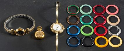 Three gilt metal dress watches, including a Gucci wristwatch with 16 vari-coloured plastic,
