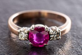 A ruby and round, brilliant-cut diamond three-stone ring, estimated ruby weight ca. 0.